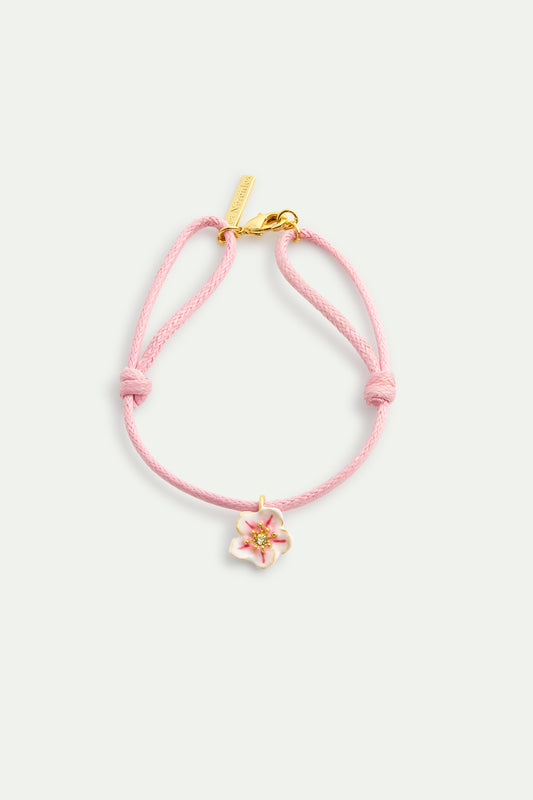 Pink thread bracelet with a tiny white cherry blossom